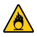 Señal de advertencia de riesgo comburente. Gráfico técnico para señalética industrial.